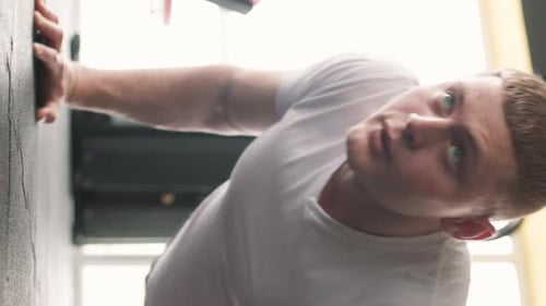 Fit and Determined Young Male Athlete Training with Pushups in the Gym
