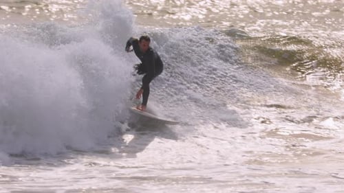 Male Surfer Riding a Wave