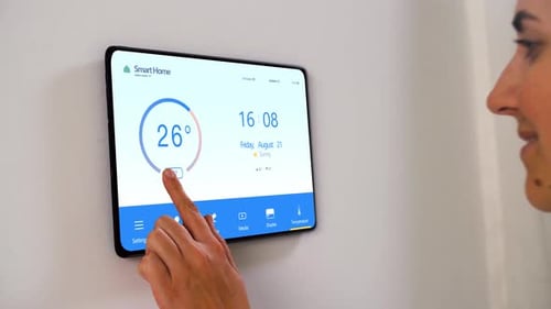 Woman Adjusting Smart Home Temperature on Digital Display