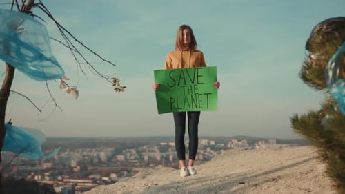 Young Woman Activist Holding Encouraging Green Poster Save the Planet Standing Around Plastic Bag