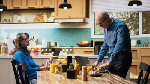 Couple Enjoying Breakfast Together in Bright Modern Kitchen