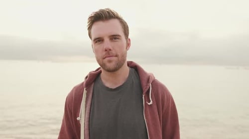 Young man standing on the beach