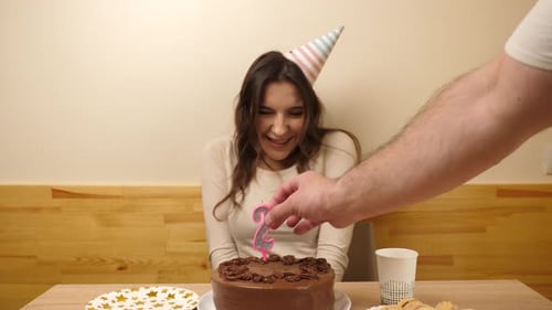 Happy Young Woman Celebrating Her Birthday with Cake