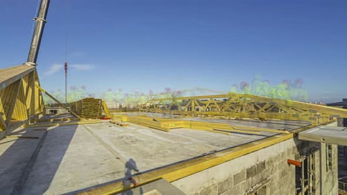 Construction Workers Installing Roof Trusses on Building