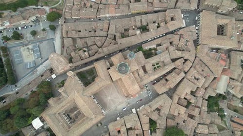 High-angle aerial view of a historic city characterized by tightly clustered stone buildings, narrow