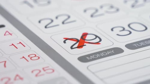 Red Marker Highlights Day on Calendar Page