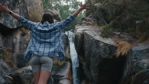Tourist Woman Rise Hands Watching Waterfall on Vacation Trip Slow Motion Shot