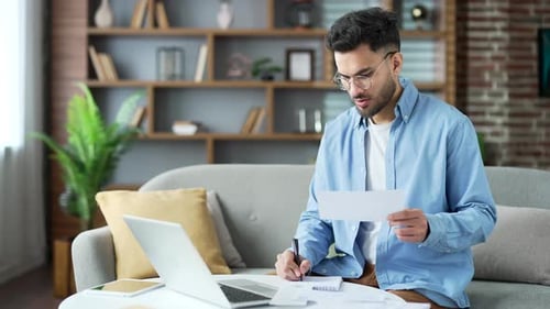 Young Adult Working on Laptop at Home