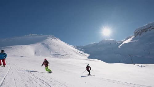 People Snowboarding and Skiing at Ski Resort - Winter Fun and Sports