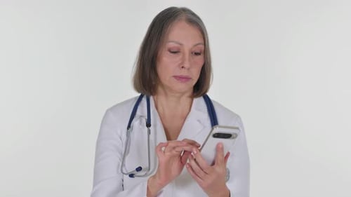 Senior Doctor Using Smartphone in Medical Setting