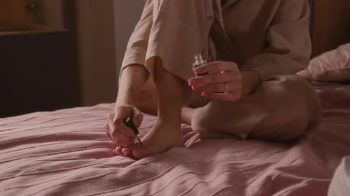 Anonymous Girl Painting Toenails with Varnish during Pampering Party