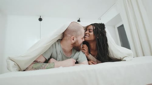 Sweet Couple Lying Together Under Bed Sheet