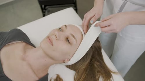 Girl receives permanent makeup treatment in a serene cosmetology studio
