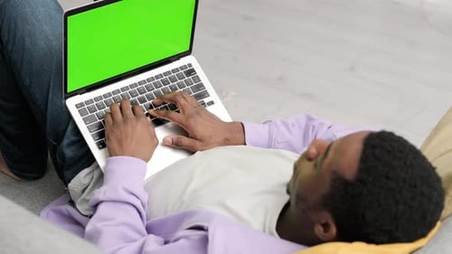 Black Man Using Laptop Notebook Viewing Green Screen Press Keyboard Browsing Chroma Key African