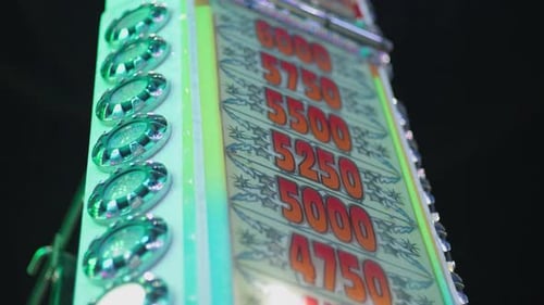 Flashing Scoreboard at Fairground Game at Night
