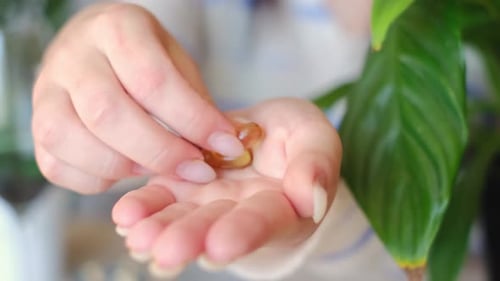 Hands Counting Vitamins in Indoor Setting
