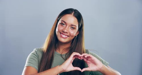 Smiling Woman Makes Heart Shape With Hands