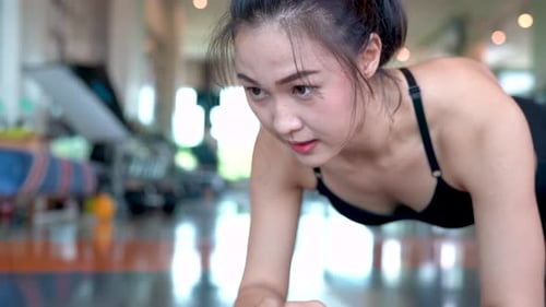 Exercise woman doing plank at gym workout fitness