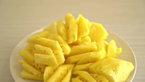fresh pineapple sliced on plate