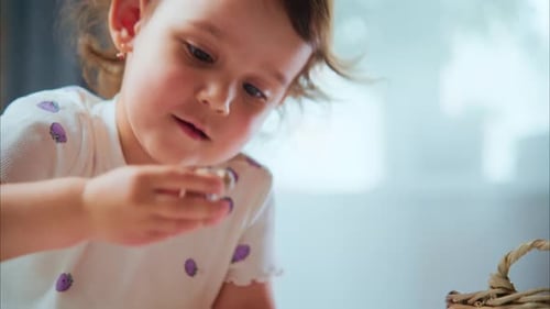 Adorable Child Playing Indoors with Small Toy