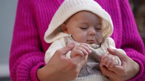 Mother Holds Infant Son Close Up in Home