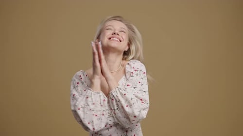 Blonde Woman Expressing Joy and Shaking Hair