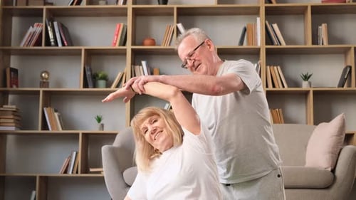 Senior Couple Exercising and Stretching at Home