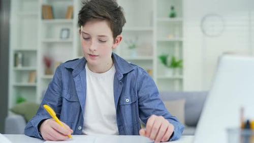 Boy Does Schoolwork on Computer at Home