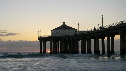 Golden hour tracking shot of a Los Angeles beach paradise at sunset
