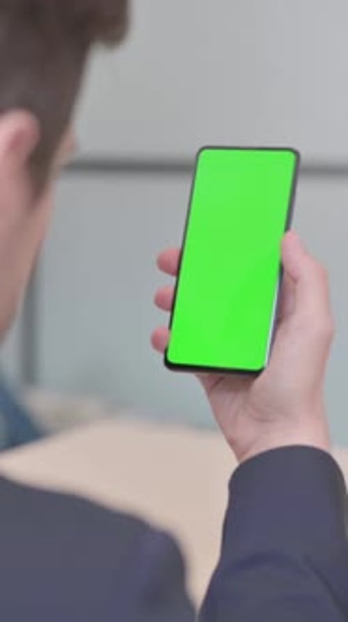 Close Up of Businessman Using Smartphone with Green Screen, vertical video
