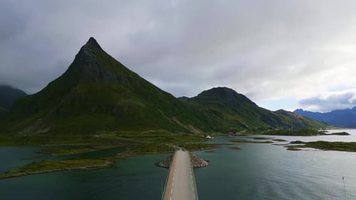 Flying along the narrow street Fredvang bridge in Lofoten Northern Norway with the sea ocean water s