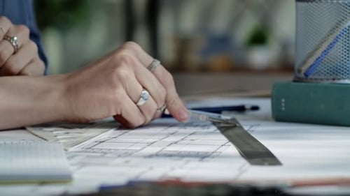 Person Using Compass and Ruler for Architectural Drafting