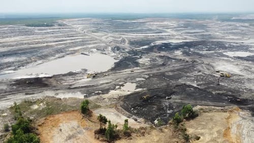 Aerial view panorama of open pit coal mining, dumper, extractive industry excavation