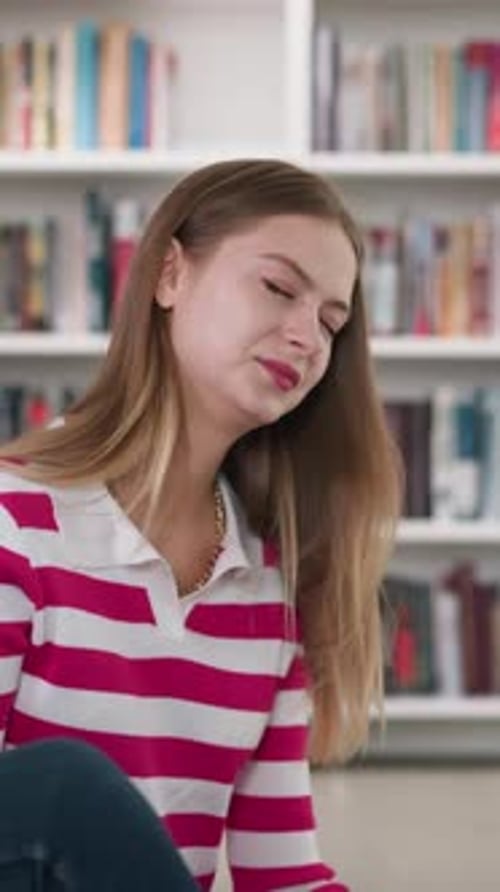 Woman Reads Book with Friends in Library