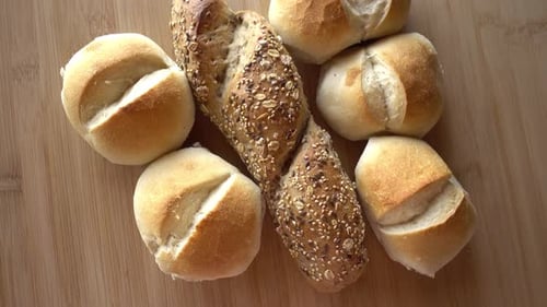 Golden Rolls and Baguette on Wood Table