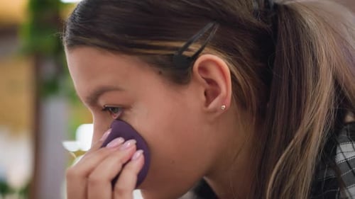 Closeup View of Lady Blending Makeup Under Left Eye Using Beauty Sponge