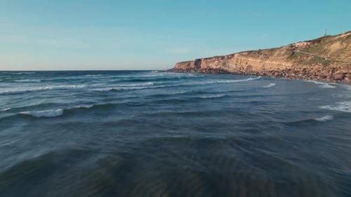 Drone footage captures waves gently rolling across vast seascape at Milan, Italy, the rhythmic motio