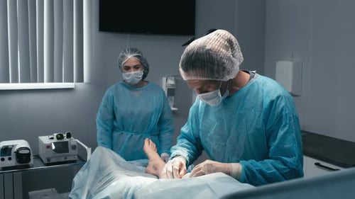 Doctors Doing Operation For Injured Patient