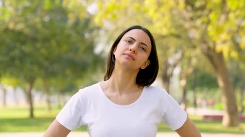 Woman Stretching Neck in Park