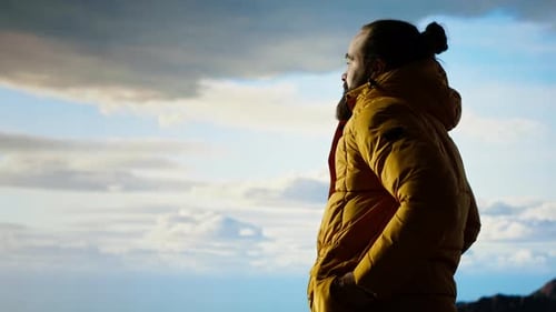 Male Trekker Takes in the Breathtaking Mountain Landscape on Rocks