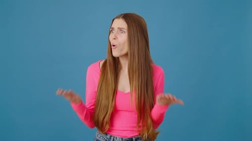 Portrait of Angry Attractive Young Adult Woman with Long Hair Asking What Arguing