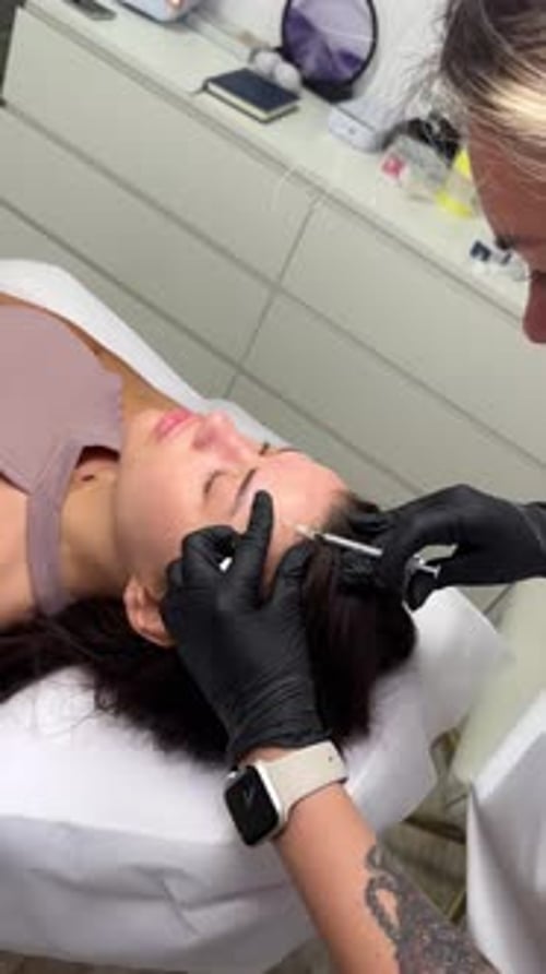 Beauty Clinic Beautician Hands in Gloves Making Face Aging Injection in a Female Skin A Woman Gets