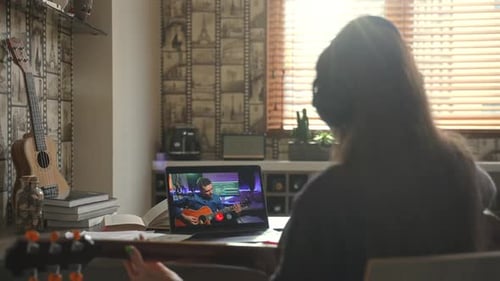 Student Takes Online Guitar Lesson at Home