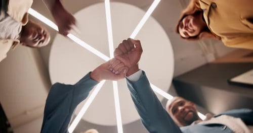Employees, people and fist bump from below at office for team building and collaboration with smile
