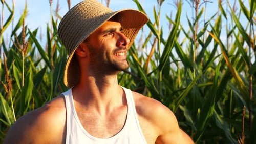 Happy Smiling Male Farmer Looks Into Camera Standing Near Corn Meadow Portrait of Young Handsome