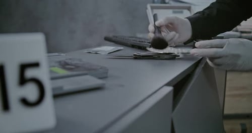 Numbered Marker Stands Next to Crime Scene Evidence Close Up of Criminalist Searching Fingerprints