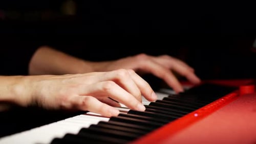 Hands Playing Red Keyboard Close Up