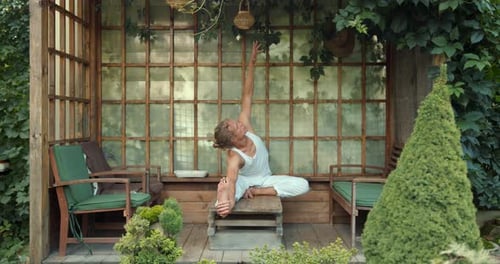 Young Man Practicing Yoga Outdoors