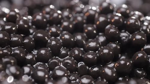 Extreme Close-Up of Glossy Black Caviar Balls