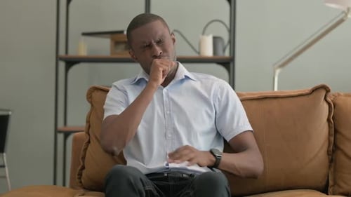 Adult Man Coughing on Couch at Home
